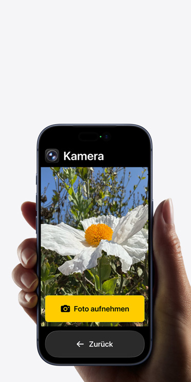 Ein iPhone 17 Pro Bildschirm mit vereinfachter Benutzeroberfl?che der Kamera App und einer wei?en Blume im Bildausschnitt, darunter die Taste ?Foto aufnehmen“ und der Taste ?Zurück“