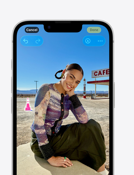 écran d’un iPhone, photo d’une personne souriant sur la plage, montrant comment supprimer un c?ne en arrière-plan avec l’outil Correction